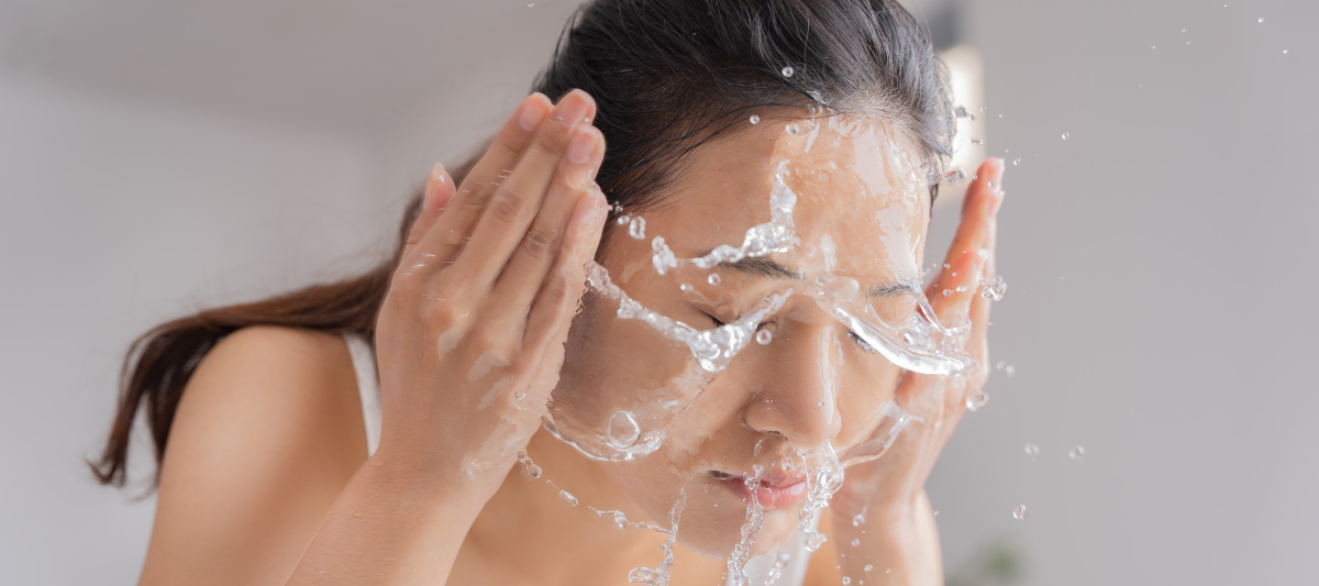 Beautiful Asian Woman Washing Face After Applying Manuka Honey for Skin