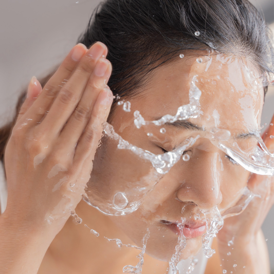 Beautiful Asian Woman Washing Face After Applying Manuka Honey for Skin